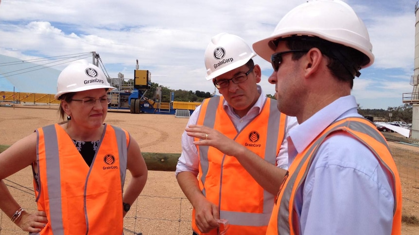 Victorian Transport Minister Jacinta Allan, Premier Daniel Andrew and Lance Brown, from GrainCorp, beside the rail freight line.