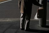 Elderly man waits at traffic lights