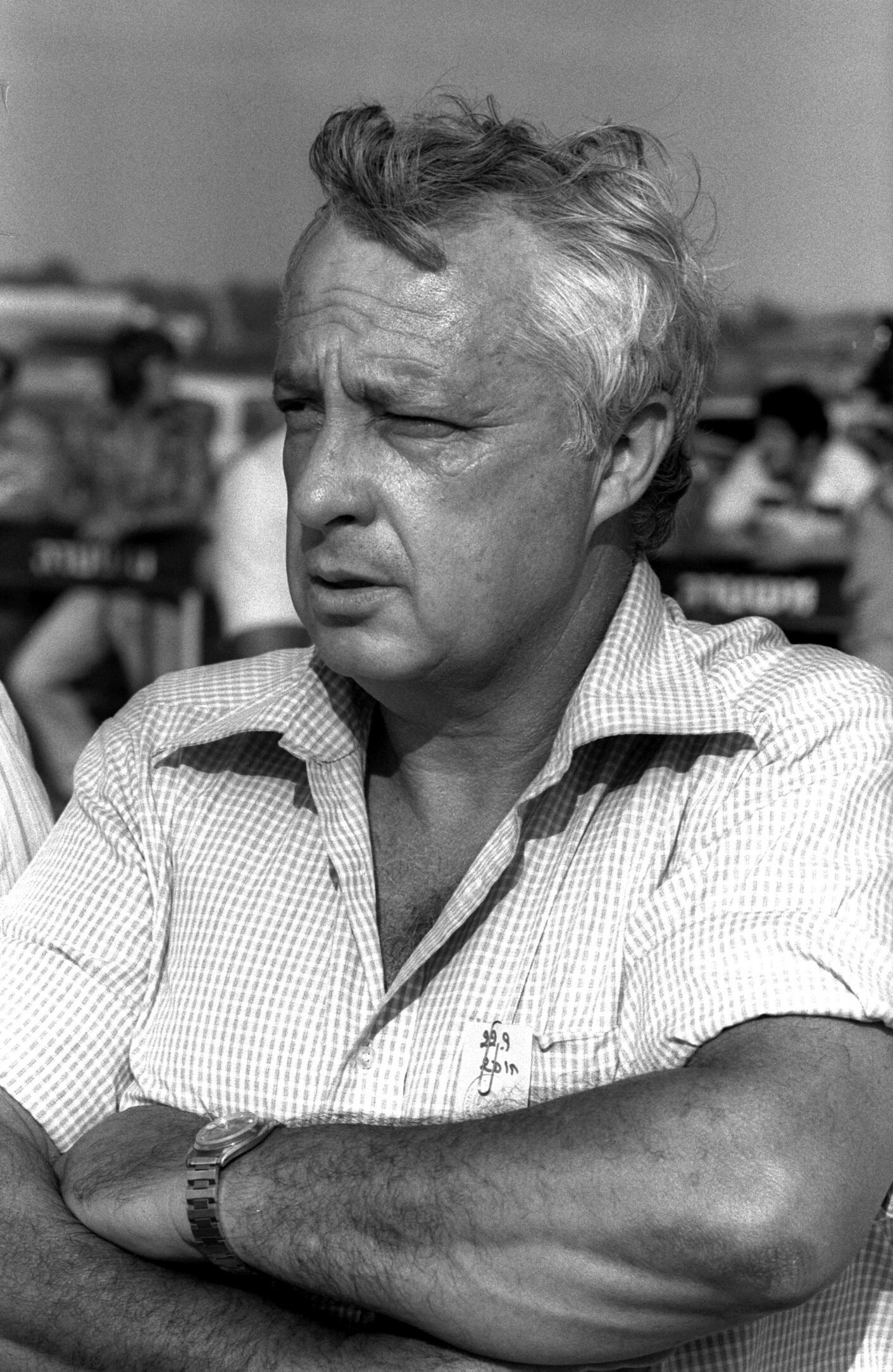 A black and white photo of a middle-aged man in the 1970s, with his arms crossed.