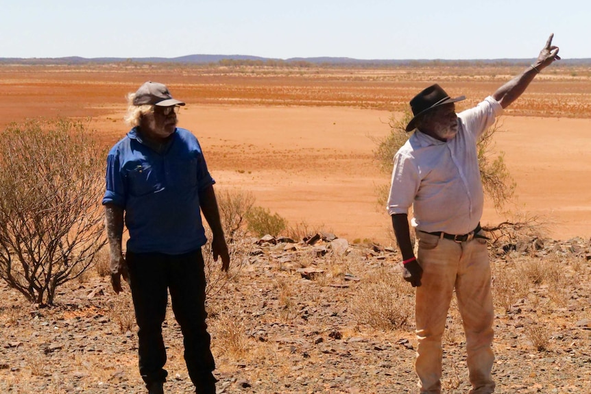 Two men standing in the Australian outback