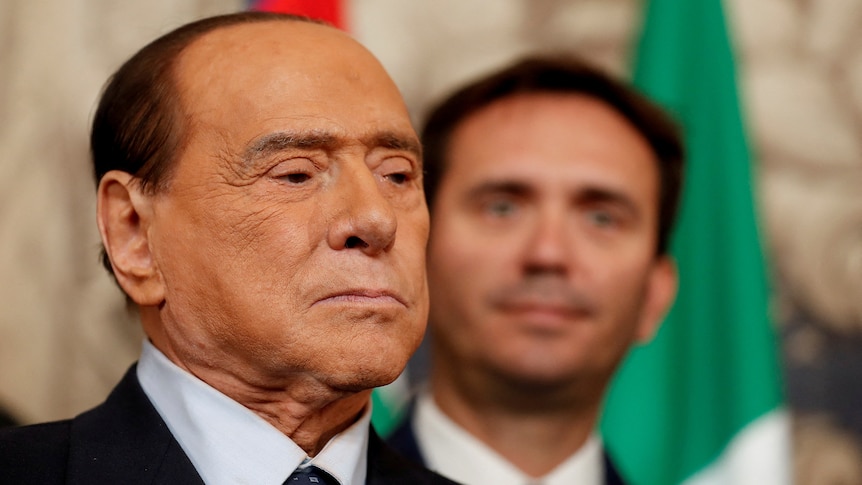 Silvio Berlusconi looks into the distance.