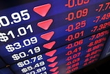 A screen displays falling share prices in Australia.