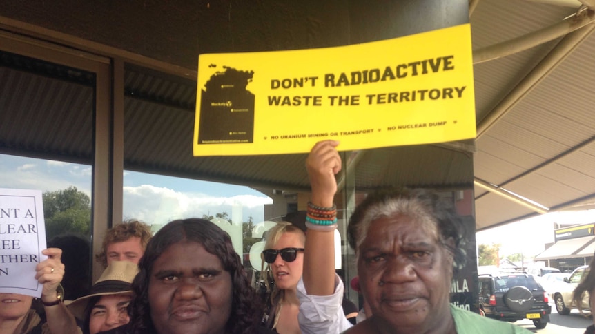 Muckaty traditional owners Kylie Sambo and Dianne Stokes at a protest waving a sign.