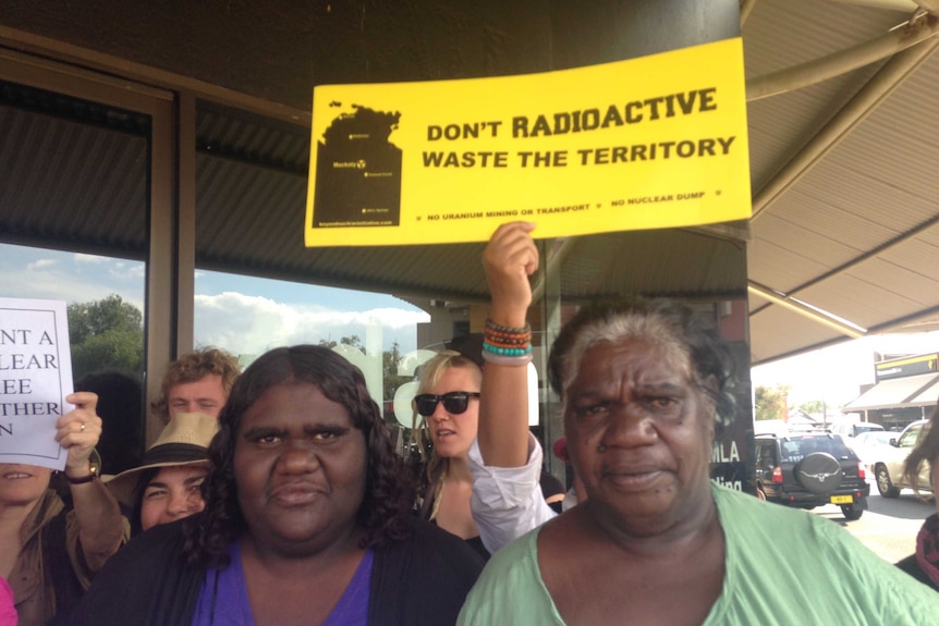 Muckaty traditional owners Kylie Sambo and Dianne Stokes at a protest waving a sign.
