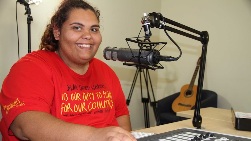 a woman in front of a microphone