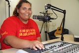 a woman in front of a microphone