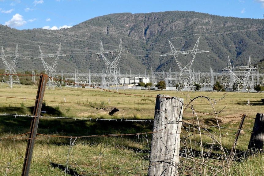 Barbed wire in front of power lines