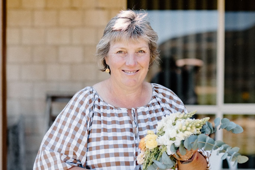 woman holding bunch of flowers