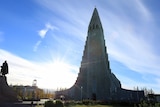 Hallgrímskirkja Cathedral is seen before blue skies as the sun shines over Reykjavik, Iceland