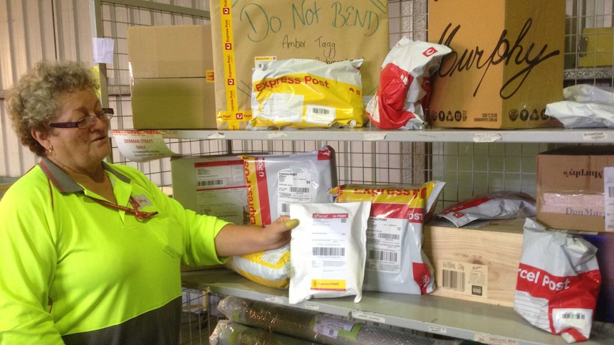 Parcels on shelves at an Australia Post delivery shed