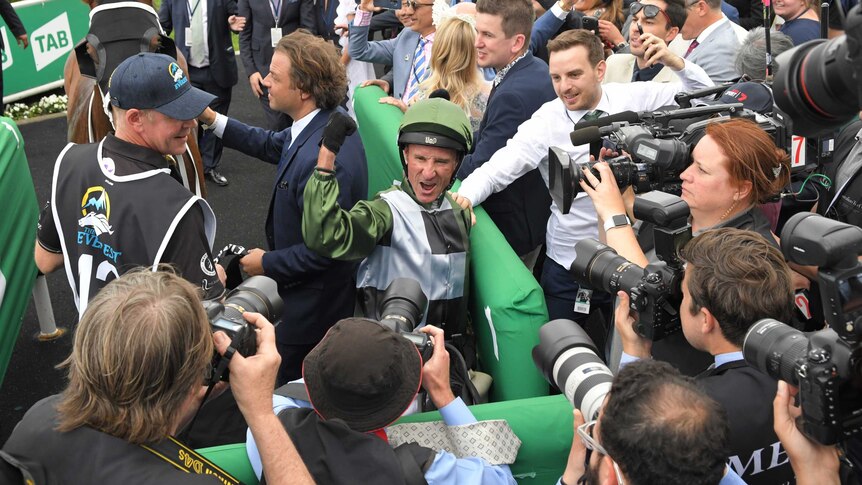 Glen Boss surrounded by media after winning the Everest in Sydney
