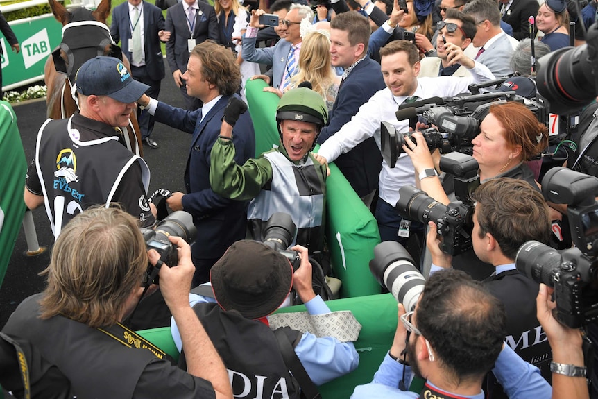 Glen Boss surrounded by media after winning the Everest in Sydney