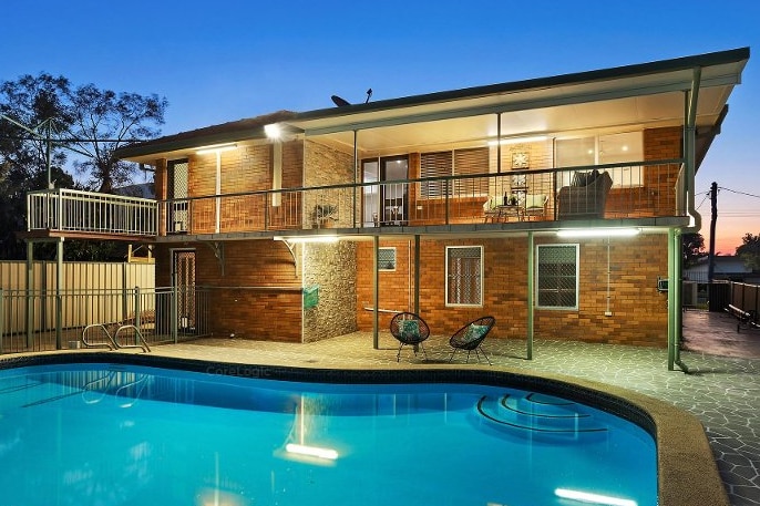 A home in Wandal, rockhampton, with a pool. 