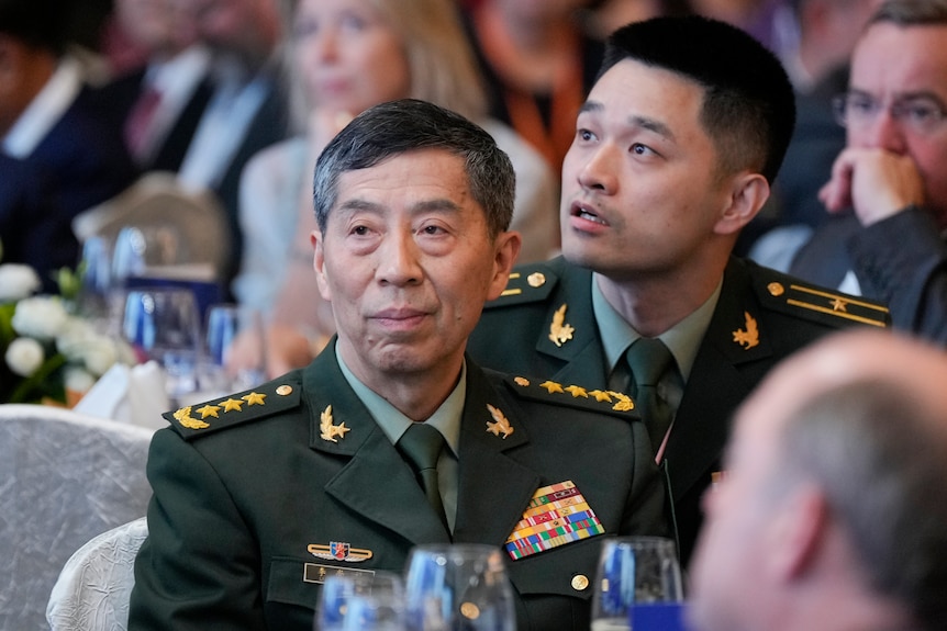 A Chinese military official wearing a military jacket with medals