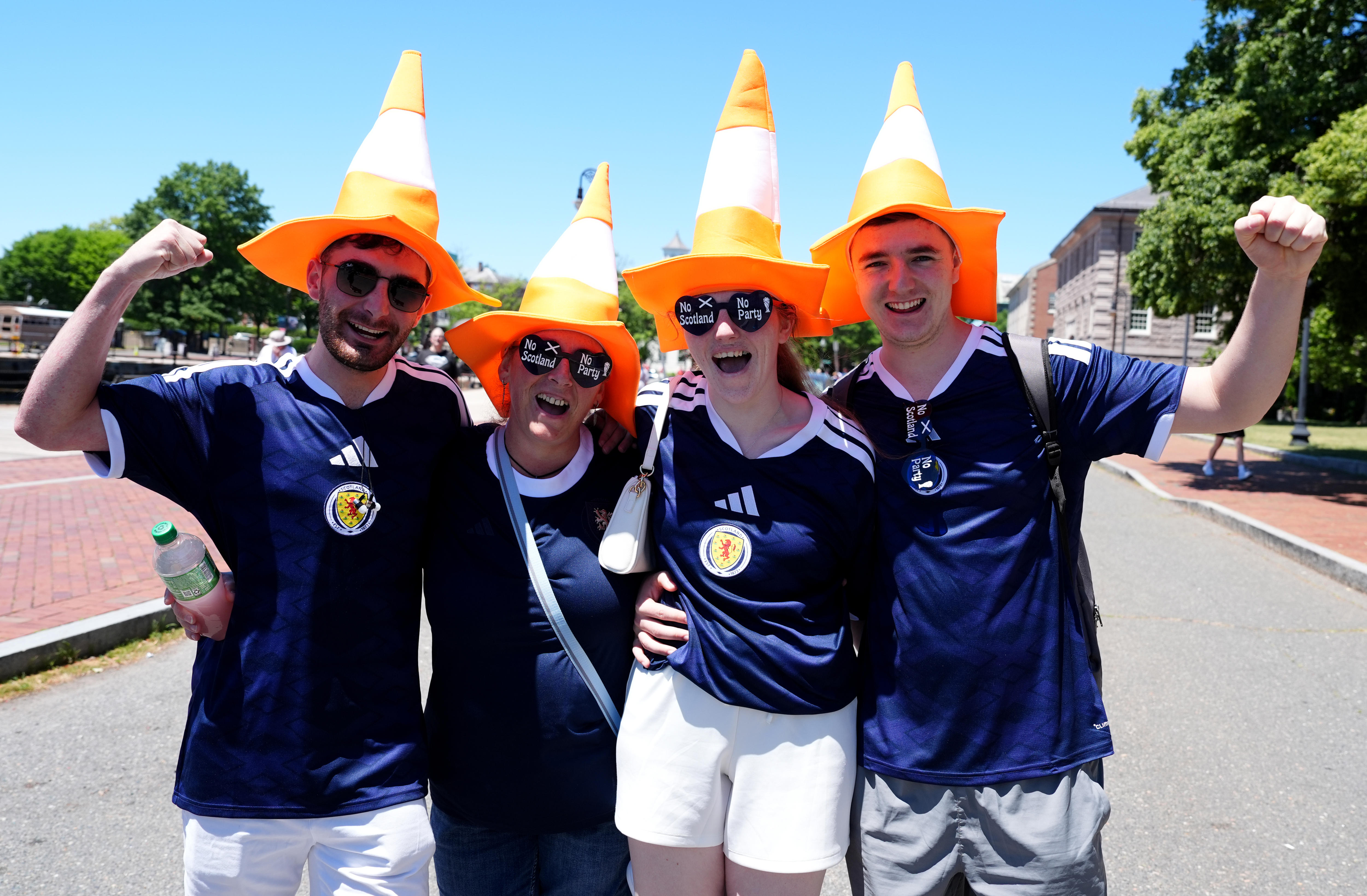 Four Scotland fans wearing traffic cones on their heads
