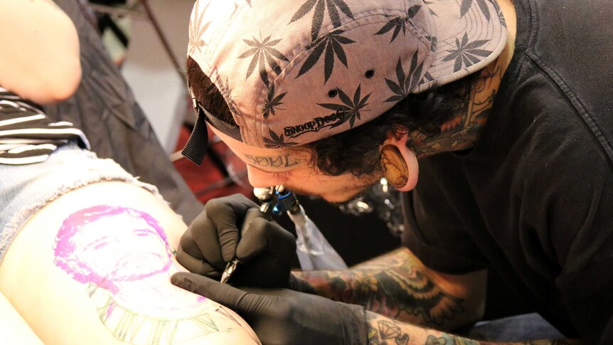 A tattoo artist at work at the Australian Tattoo and Body Art Expo in Perth, June 6, 2014.