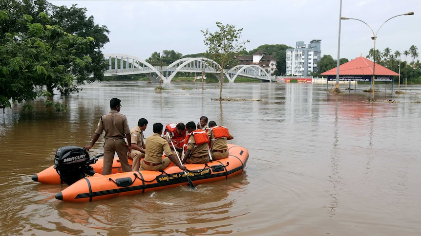 Rescue personnel patrol the flooded waters on the banks of Periyar River in India.