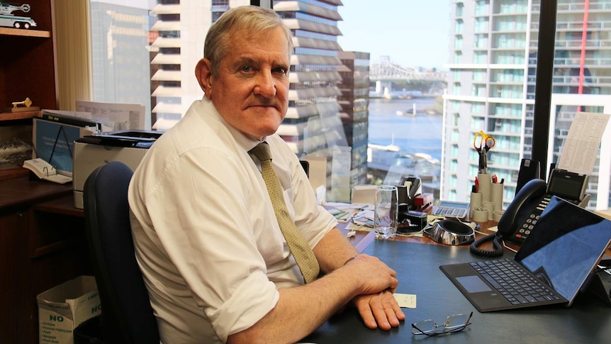 Ian Macfarlane sits at his desk at his office in Brisbane.