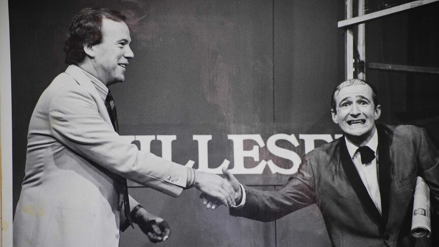 A black and white photo of Mike Willesee shaking Norman Gunston's hand