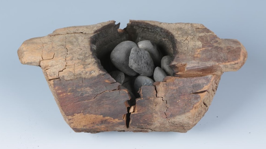 Wooden brazier with burnt stones