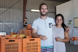 two backpackers in packing shed