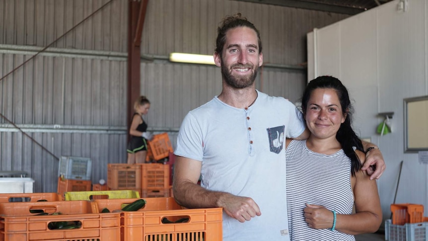 two backpackers in packing shed