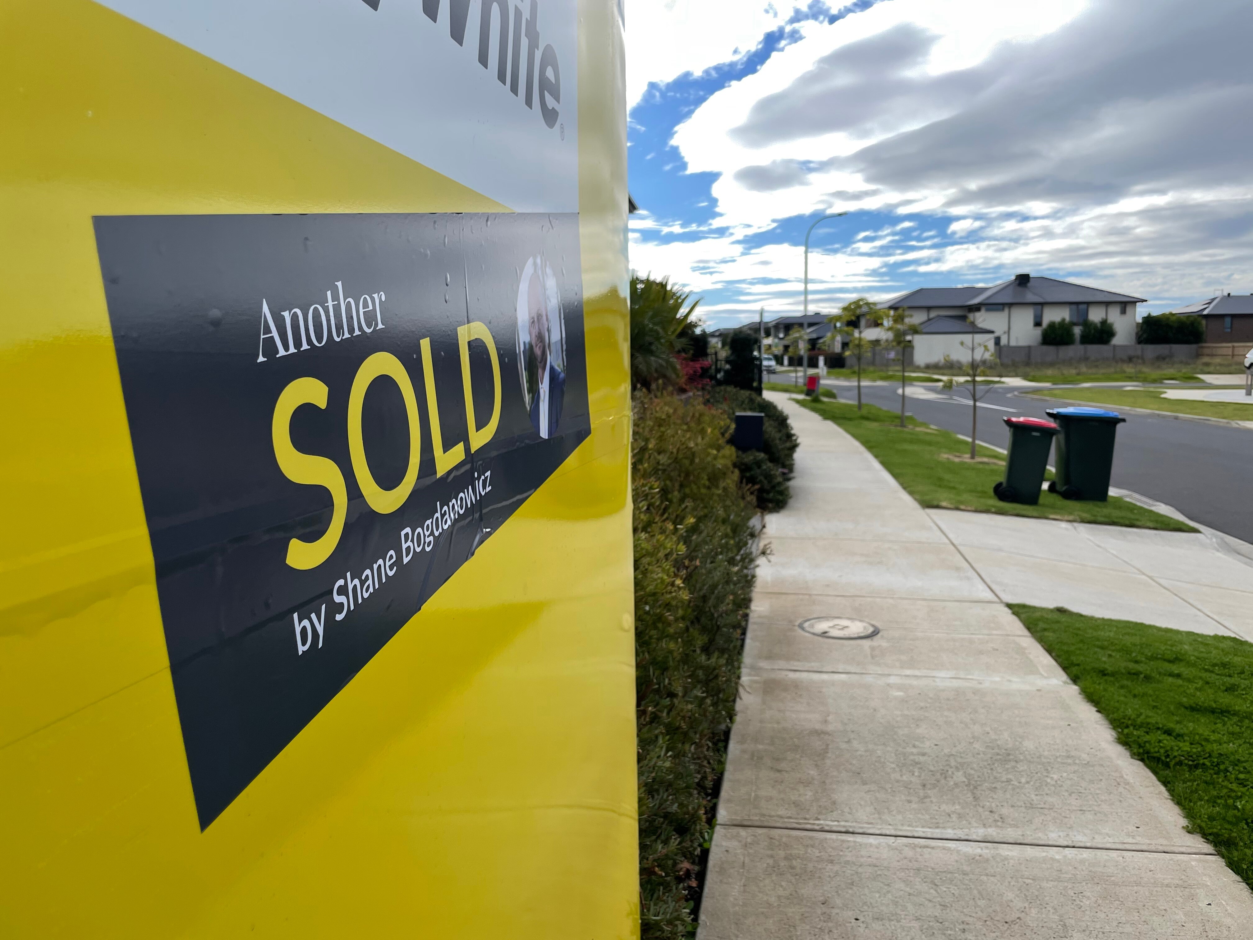 A sold sticker on a real estate sign.