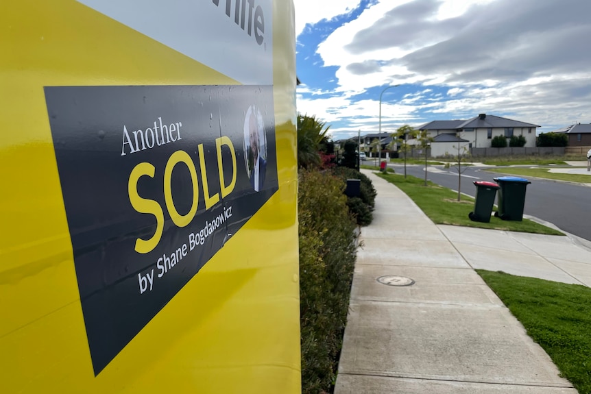 A sold sticker on a real estate sign.