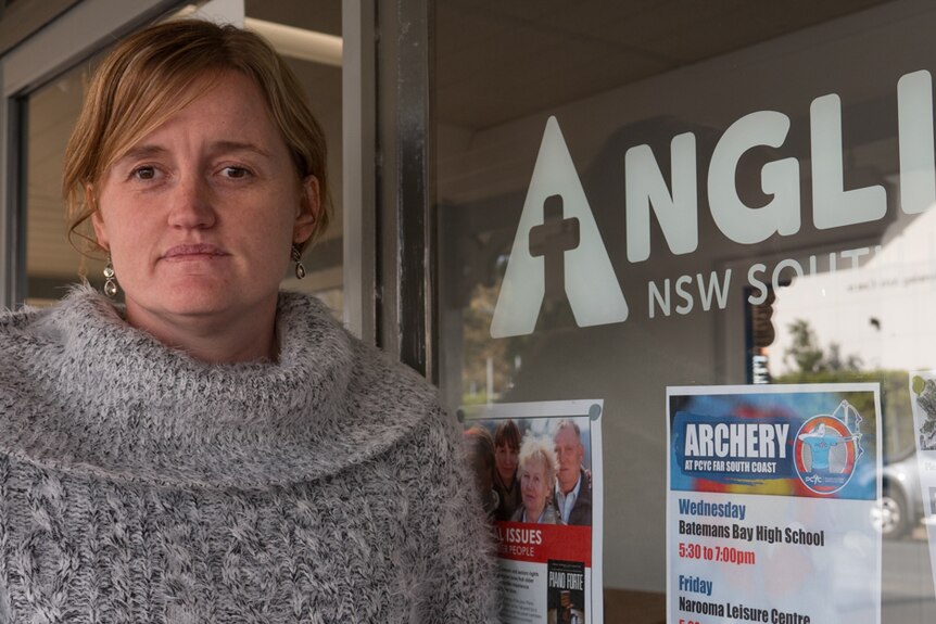 Woman standing outside an Anglicare office