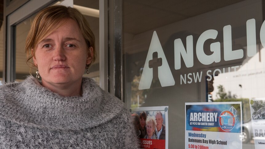 Woman standing outside an Anglicare office