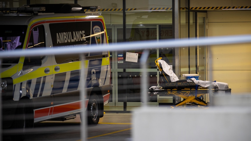 A gurney sits next to an ambulance outside Launceston General Hospital.