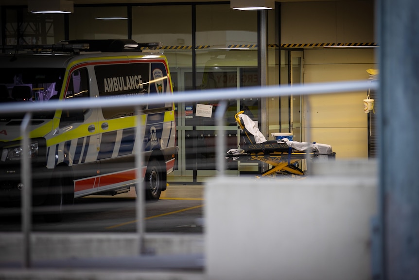 A gurney sits next to an ambulance outside Launceston General Hospital.