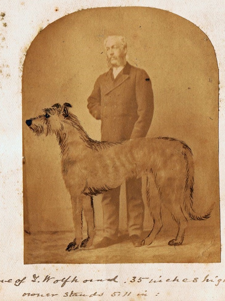 A black and white image of George Graham next to a dog, he is facing the camera