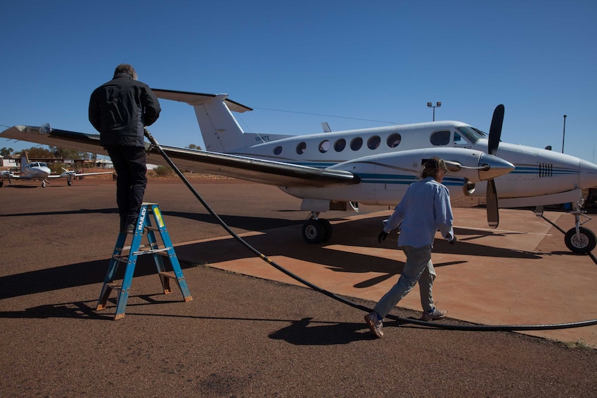 Airstrip staff in Warburton, WA refuel a plane chartered by the AEC for remote polling.