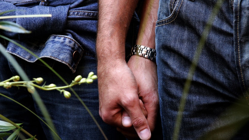A gay couple hold hands during a symbolic wedding ceremony (Max Rossi, Reuters)