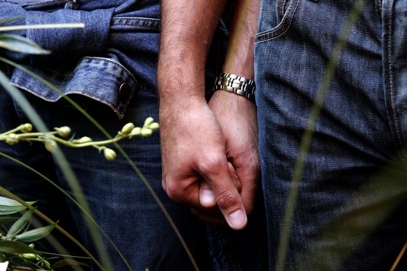 A gay couple hold hands during a symbolic wedding ceremony (Max Rossi, Reuters)