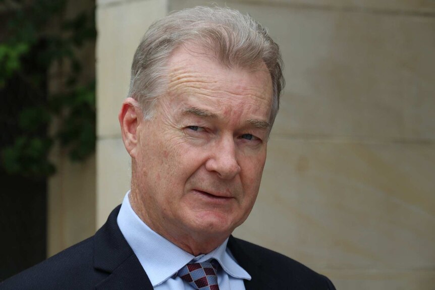 A headshot of Paul Armstrong outside of a building in Perth