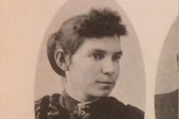 An old photo featuring a woman from the 1800's with dark features.