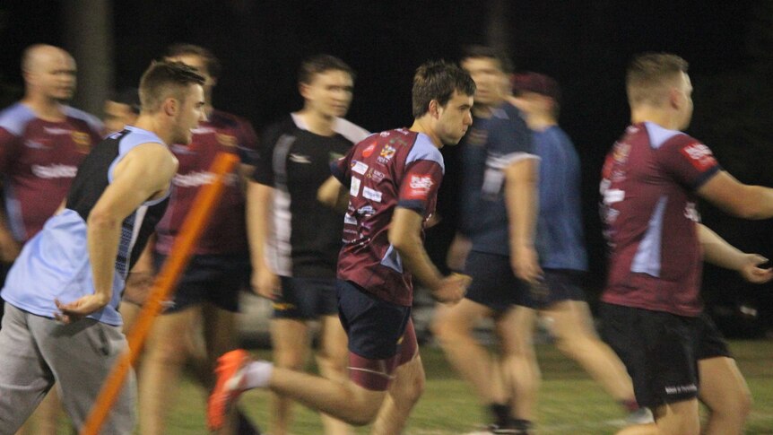 An action shot of Connor running on the rugby field.