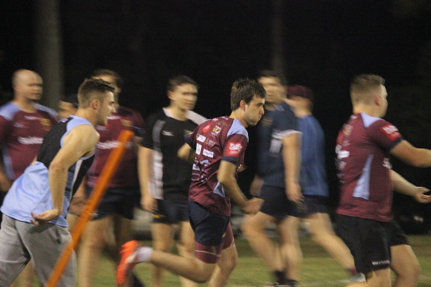 An action shot of Connor running on the rugby field.