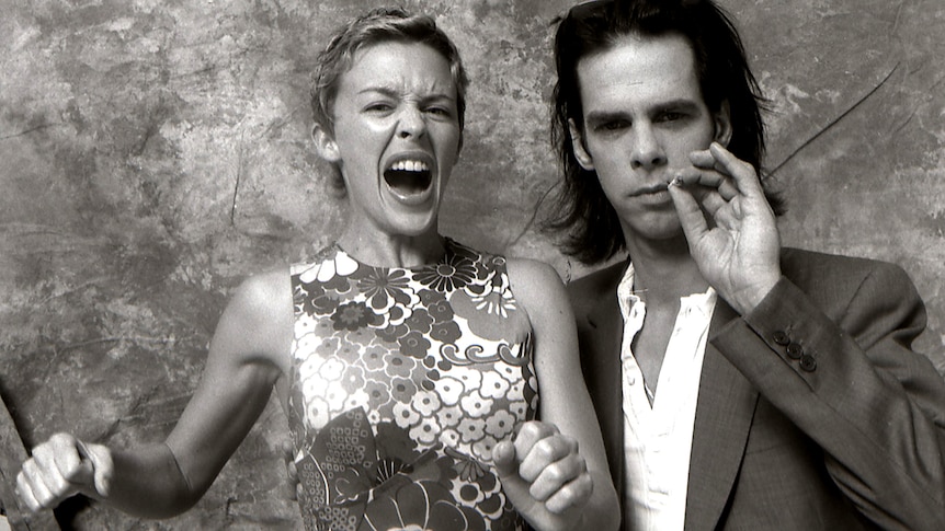 Black and white photo of Kylie Minogue with her mouth open and Nick Cave smoking