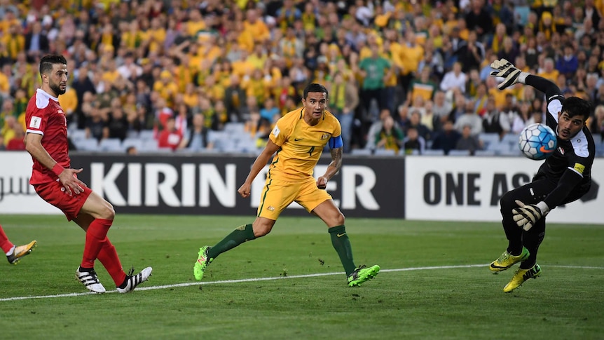 Australia's Tim Cahill headers the ball to score a goal.