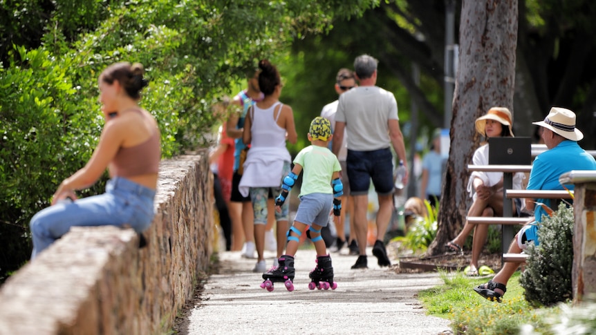 People enjoying outdoors running, walking rollerblading on a sunny autumn day at Kangaroo Point in Brisbane