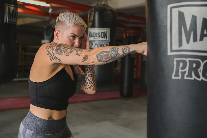 Bec Rodriguez punching a boxing bag during training.