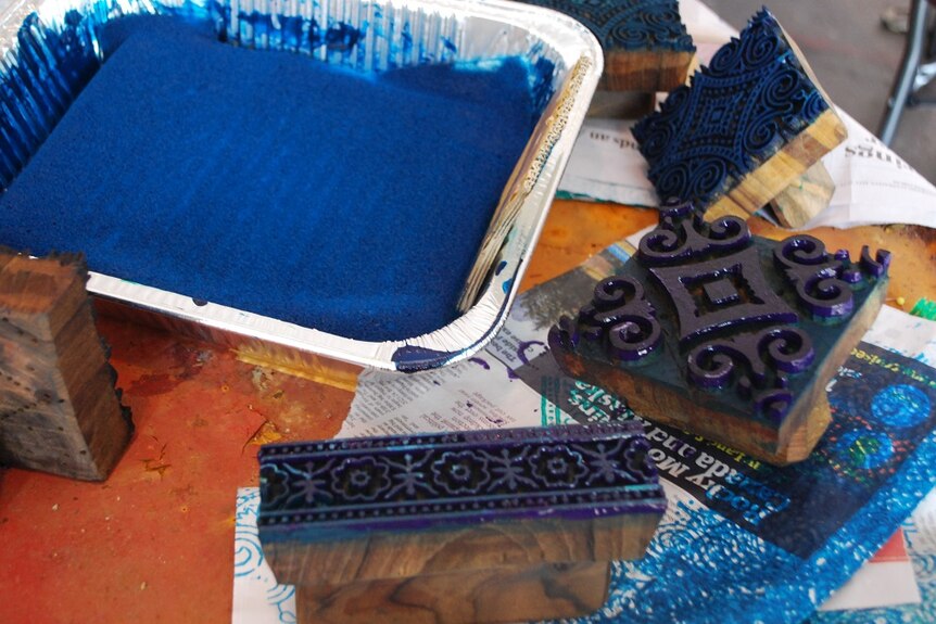 The intricate, wooden printing blocks dipped in blue paint