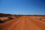A stretch of red dirt road.