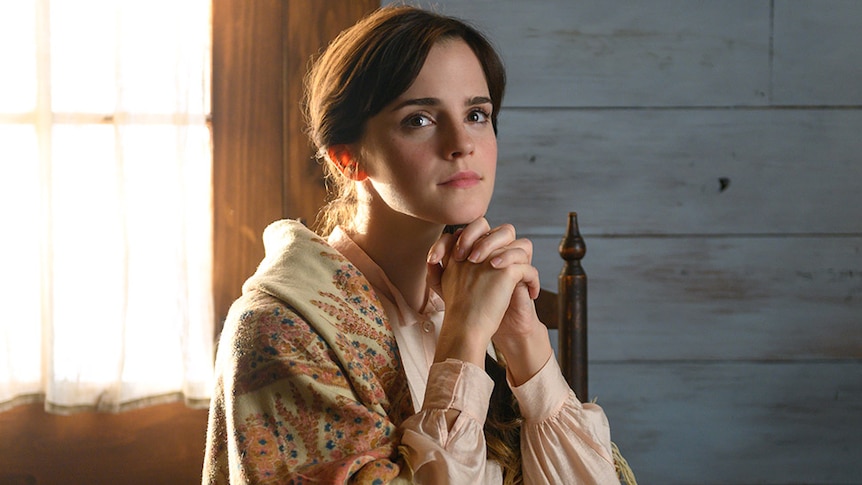 Emma Watson sitting at a desk in Little Women for list of films and TV shows dads and daughters should watch together