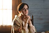 Emma Watson sitting at a desk in Little Women for list of films and TV shows dads and daughters should watch together