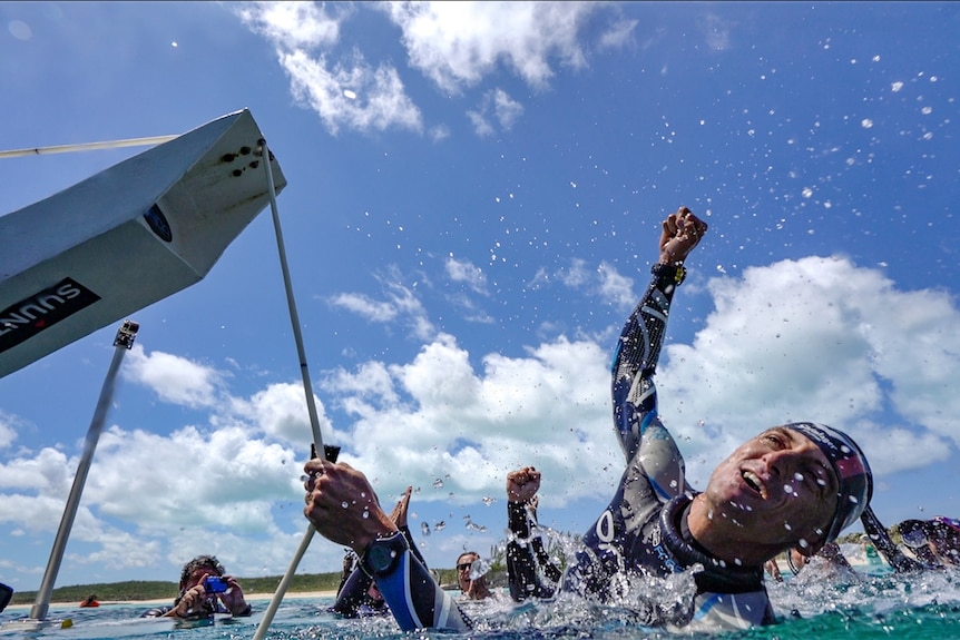 William Trubridge's cheers in the water after breaking the world record.