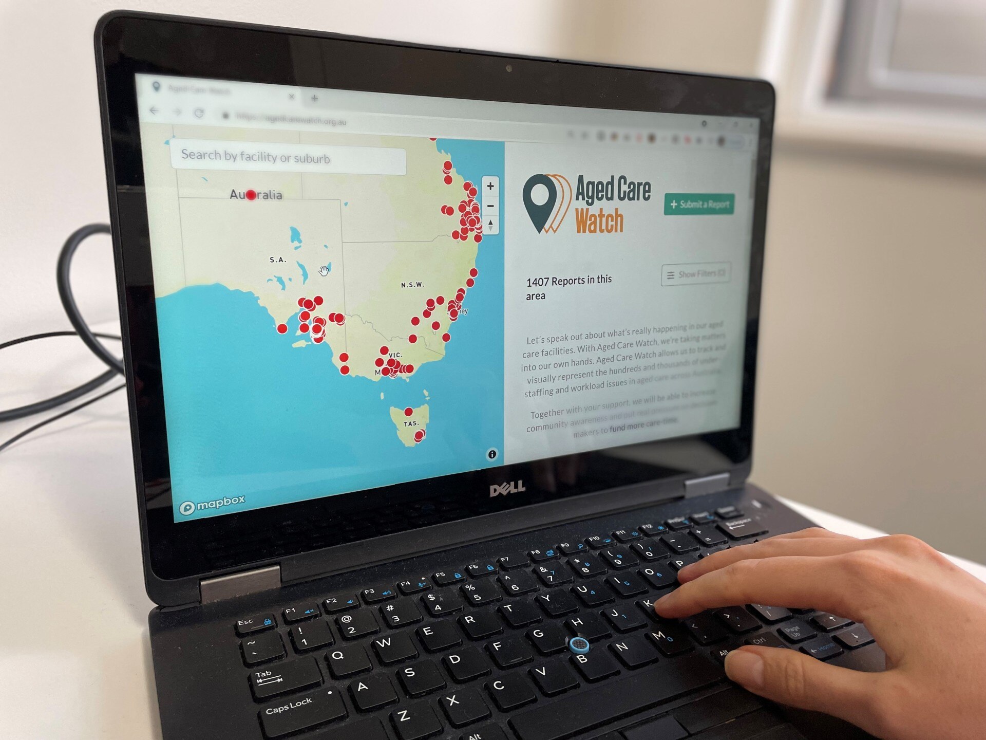 A photo of a person using the website Aged Care Watch.